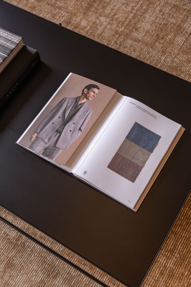 a dimly-lit & cozy showroom with a catalogue on the table