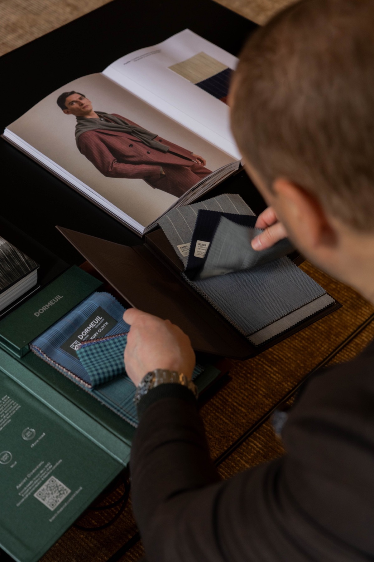 A client examines fabric swatches by natural light in the private Toorak showroom