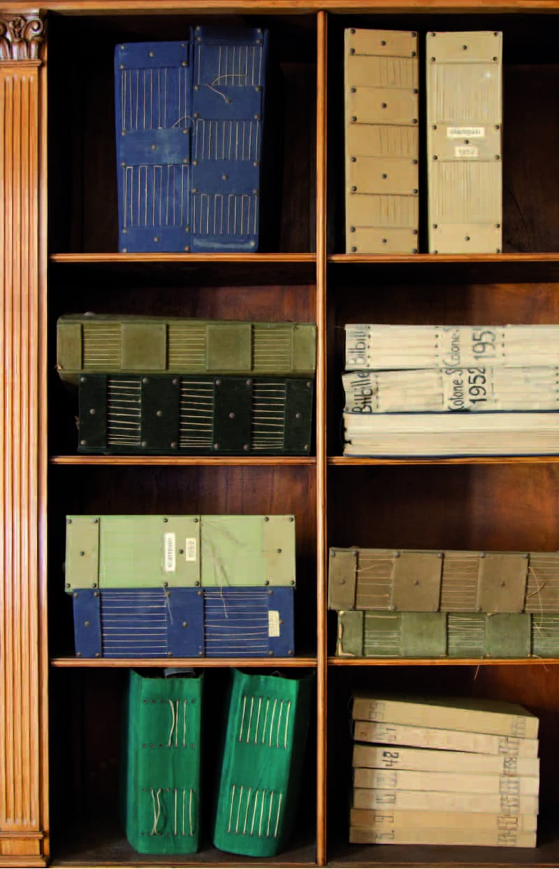Antique fabric tools stacked on a shelf