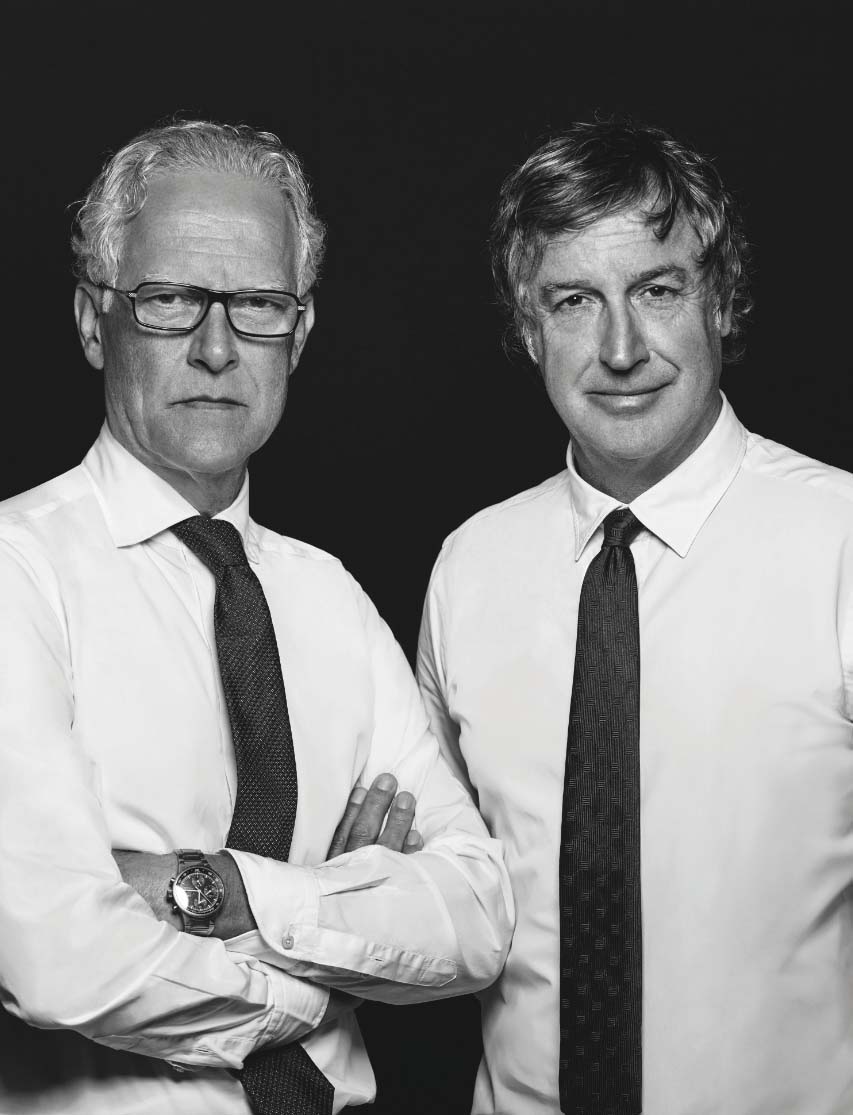Black & white portrait of two men wearing white shirts and ties, standing side-by-side