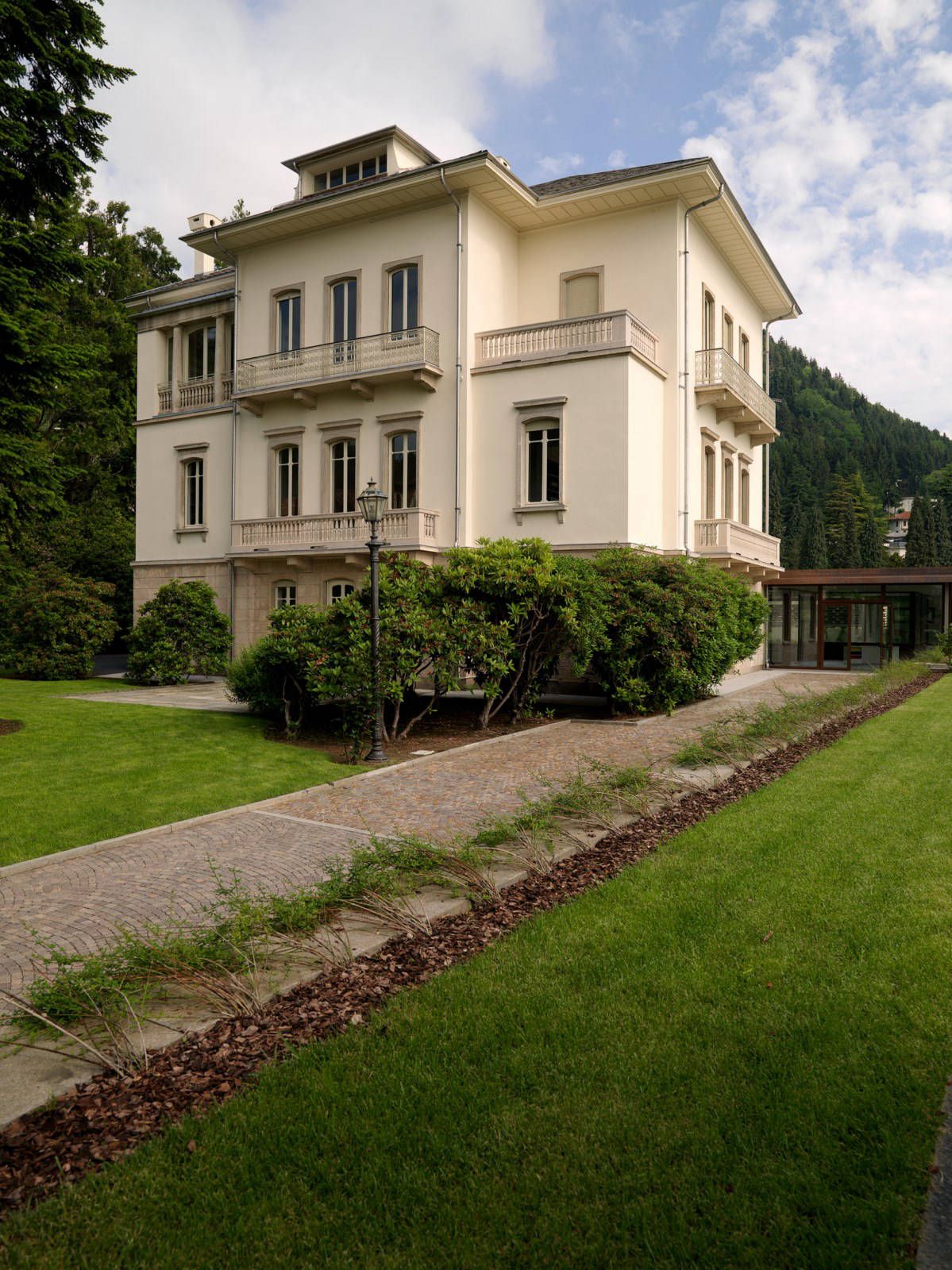 A beautiful antique triple-story home surrounded by greenery